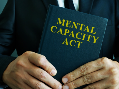 Mental Capacity Book in a persons hands