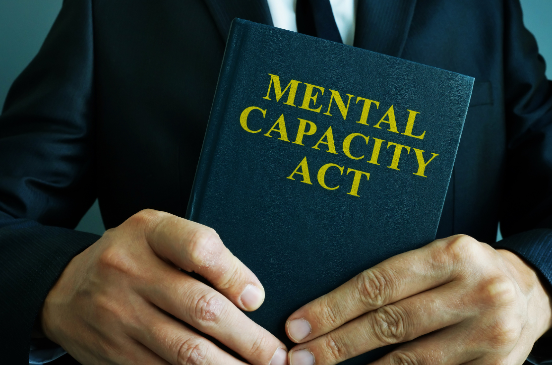 Mental Capacity Book in a persons hands